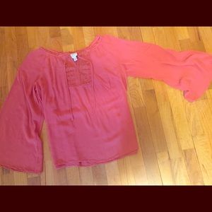 Rust-orange top with bell sleeves, size M